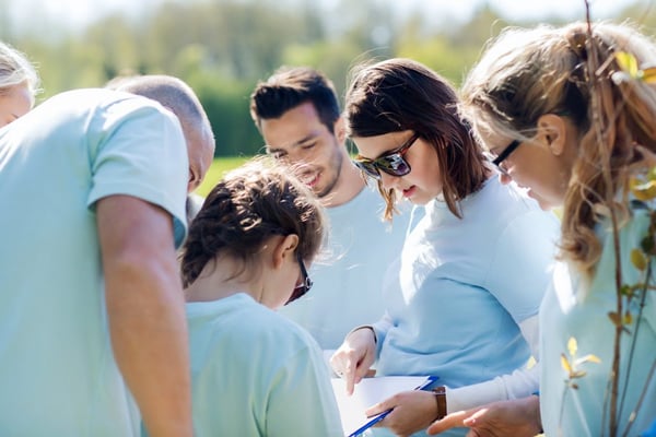 Group of volunteers looking over clipboard