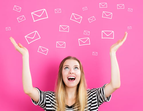 Woman gestures to envelope illustrations on pink background