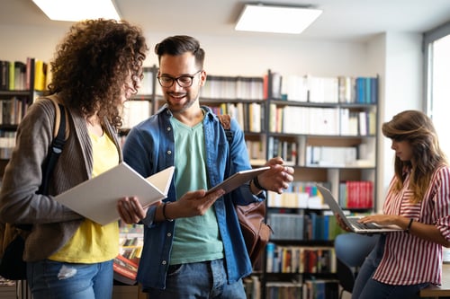 School fundraising ideas: Two students talk in library