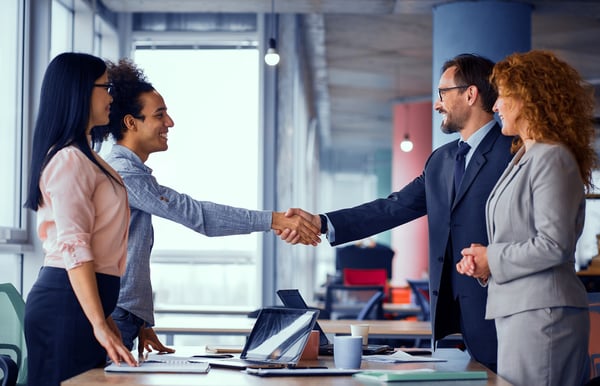 Matching gift program: People at meeting room shaking hands