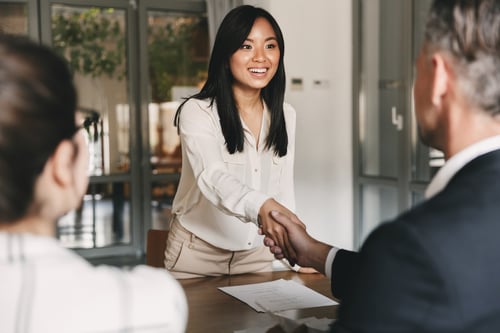 Corporate giving: Woman shaking hands with the employer