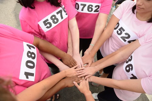 big money fundraising ideas: group of people stacking their hands