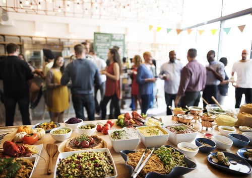 food on the table and people gathering