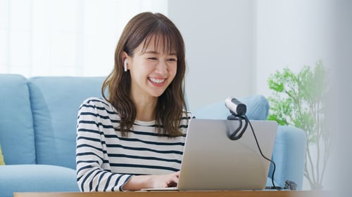 Donor cultivation: Woman smiling  while working on her laptop