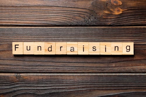 Donor development strategies: Wooden Scrabble tiles that spell out "Fundraising"