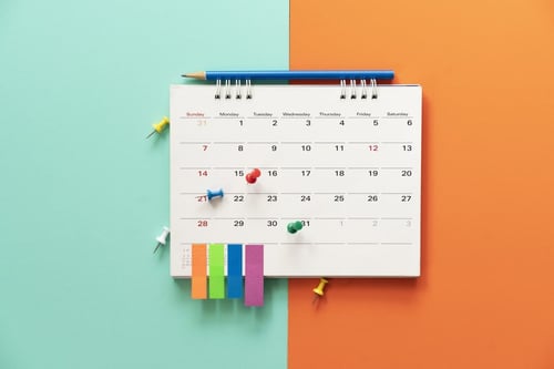 Calendar with pins and sticky notes