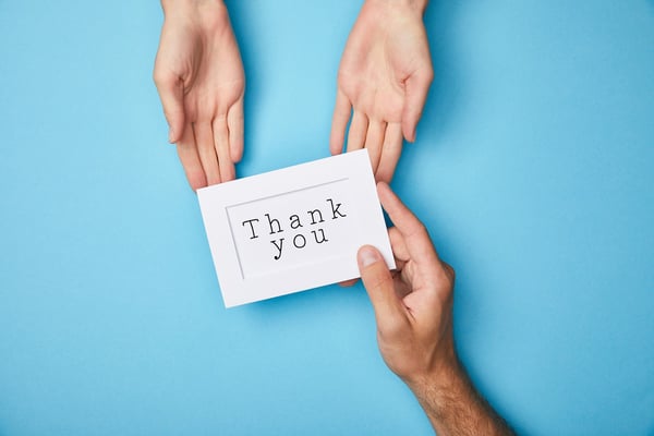 giving a thank you card