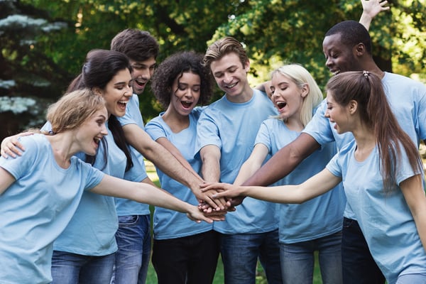 Group of people stacking hands